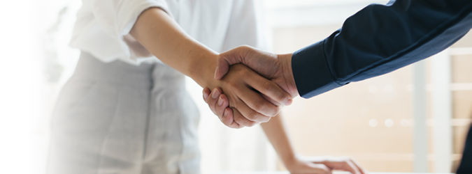 Picture of two people shaking hands.