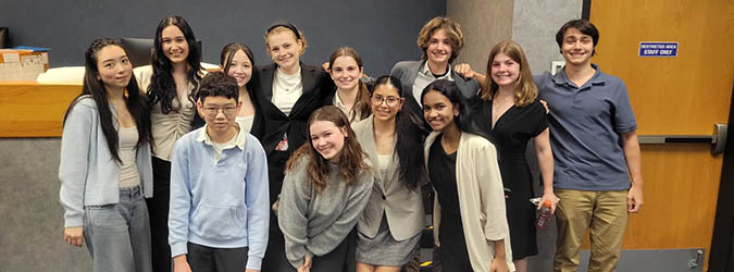 Picture of Monroe County Mock Trial Team standing together in a classroom.