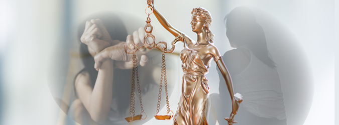 A bronze Lady Justice statue holds scales in the foreground, while a blurred image of a person with their hands restrained by another person is visible in the background.